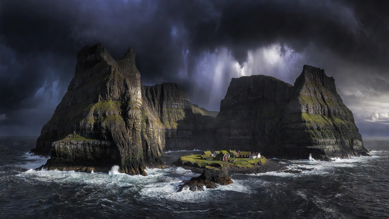 Dark sea cliffs of the Faroe Islands under storm light, with a village visible at the head of a fjord